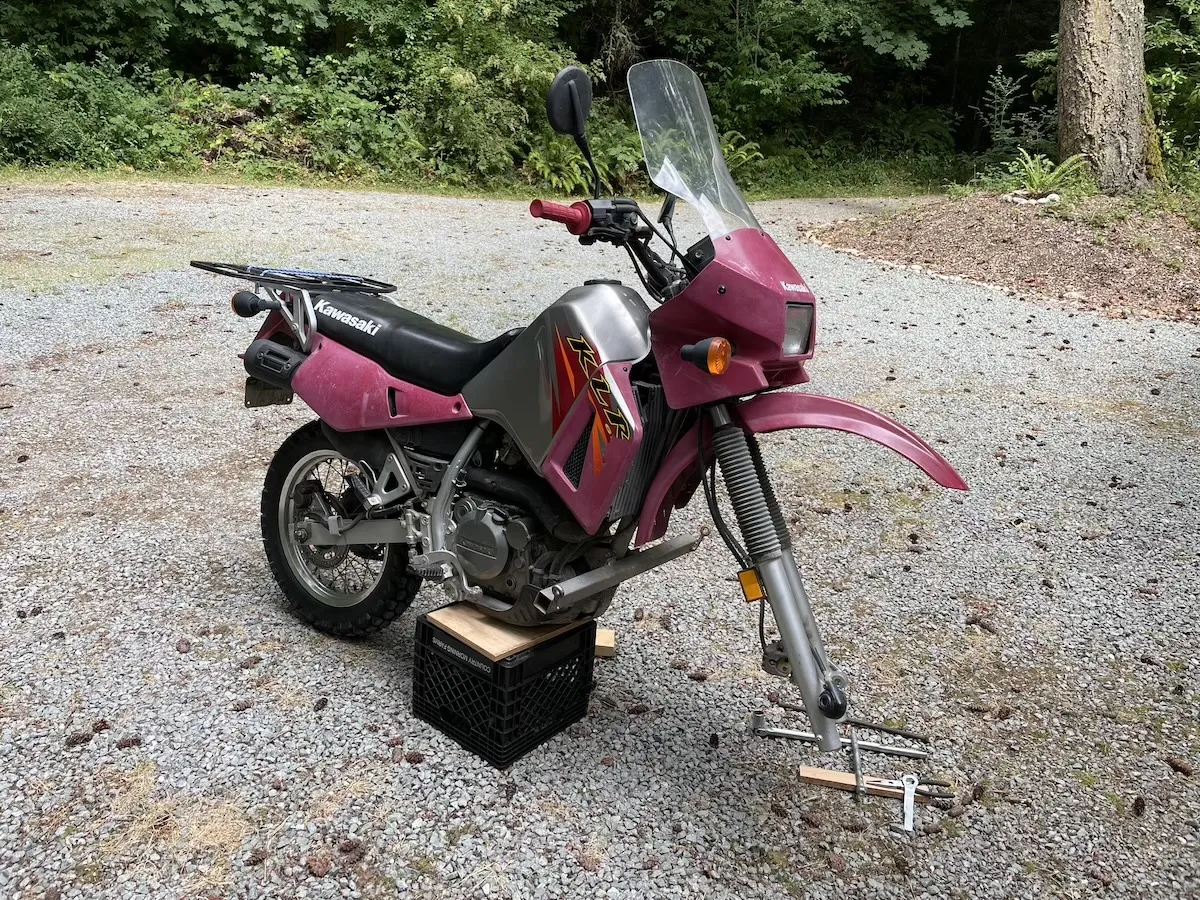 The KLR 650 propped up with the front wheel removed